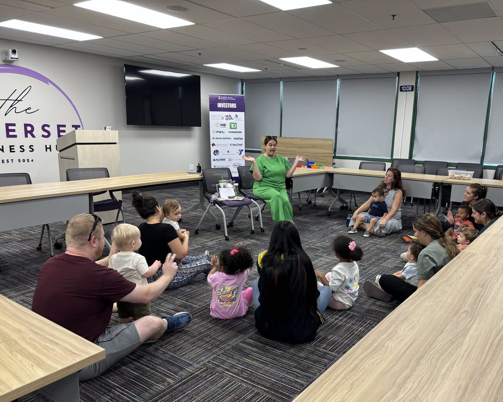 Children and caregivers enjoy a group storytime activity.